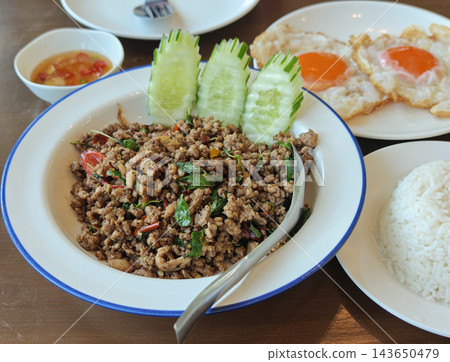 Authentic Thai basil stir-fry with fried egg and rice, delicious Thai food, appetizing food photography. 143650479