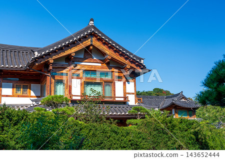 Traditional Korean Hanok Houses and Tiled Roofs against Bukhansan Mountain in Eunpyeong Hanok Village, Seoul Traditional Korean Hanok Houses and Tiled Roofs against Bukhansan Mountain in Eunpyeong Hanok Village, Seoul 143652444