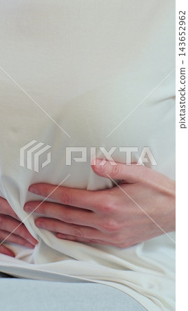 Vertical video. Woman feeling abdominal, ulcer in her tummy at home. Unrecognizable woman feels bad digestive problems abdominal pain. People health care. Vertical video. Woman feeling abdominal, ulcer in her tummy at home. Unrecognizable woman feels bad digestive problems abdominal pain. People health care. 143652962