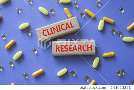 CLINICAL RESEARCH symbol. Concept word CLINICAL RESEARCH on wooden blocks. Beautiful purple background with pills. Medicine and CLINICAL RESEARCH. Copy space CLINICAL RESEARCH symbol. Concept word CLINICAL RESEARCH on wooden blocks. Beautiful purple background with pills. Medicine and CLINICAL RESEARCH. Copy space 143653238