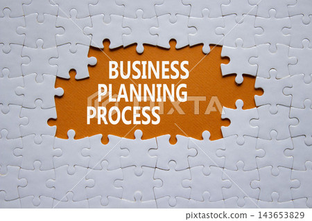 Business Planning Process symbol. White puzzle with words Business Planning Process. Beautiful orange background. Business concept. Copy space. Business Planning Process symbol. White puzzle with words Business Planning Process. Beautiful orange background. Business concept. Copy space. 143653829