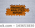 Financial Analytics Report symbol. White puzzle with words Financial Analytics Report. Beautiful orange background. Business concept. Copy space. 143653830