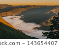 Golden Sunrise over Fog Filled Mountain Valley 143654407