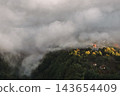 Aerial View of Mountain Village in Morning Fog 143654409
