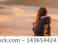 Woman Watching Sunrise above Mountain Valley 143654424