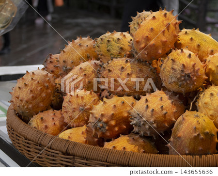 A close-up view of a tray of exotic horned melons on the street in China 143655636