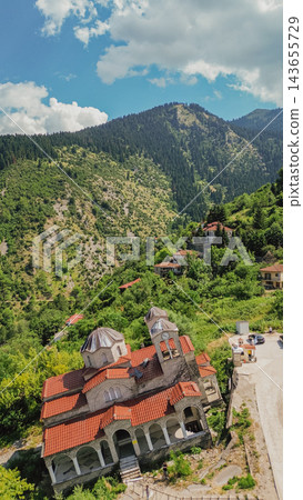 Aerial view of leaning Panagia Theotokos church in sunken ghost village Ropoto caused by severe landslide in Thessaly, Greece, surrounded by mountains Aerial view of leaning Panagia Theotokos church in sunken ghost village Ropoto caused by severe landslide in Thessaly, Greece, surrounded by mountains 143655729