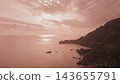 Aerial panoramic view of rocky sea coast and dark cliff silhouette under hazy pink sunset light in Greece for mysterious dramatic landscape background 143655791