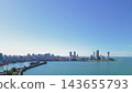 Aerial view of Batumi cityscape and Black Sea coastline with modern skyscrapers and seaport bay under blue sky in Adjara Georgia on sunny day 143655793
