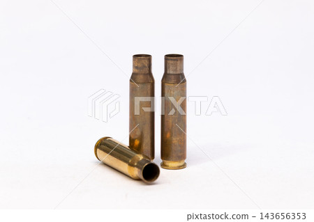 Three Empty Brass Bullet Casings Isolated on White Studio Background 143656353