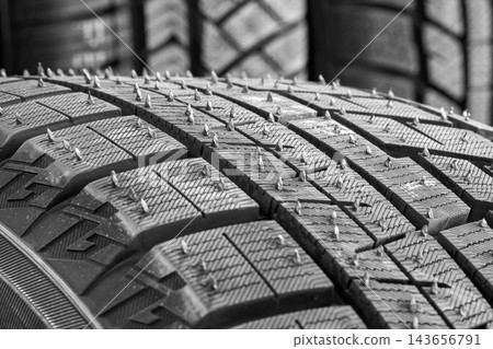 Close-Up of New Winter Tire Tread with Rubber Nibs, Vent Spews and Deep Grooves for Snow and Ice Traction Close-Up of New Winter Tire Tread with Rubber Nibs, Vent Spews and Deep Grooves for Snow and Ice Traction 143656791
