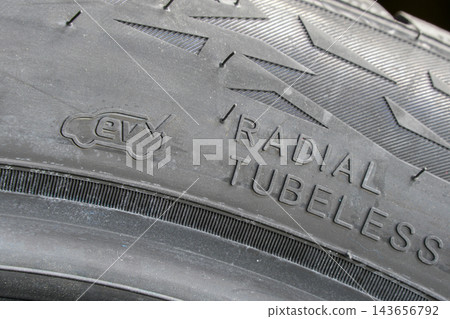 Electric Vehicle Compatible EV Tire Sidewall with Radial Tubeless Marking and Rubber Tread Detail Electric Vehicle Compatible EV Tire Sidewall with Radial Tubeless Marking and Rubber Tread Detail 143656792