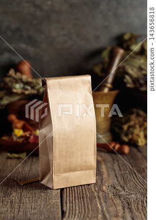 Tall brown paper bag on an old wooden table. 143656818