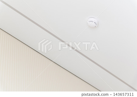 Smoke detector mounted on a white ceiling Smoke detector mounted on a white ceiling 143657311