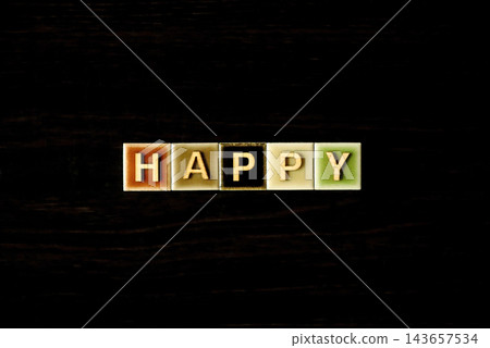 色彩繽紛的瓷磚和木製字母拼出「HAPPY」:表達幸福、快樂、積極和祝福的概念。 色彩繽紛的瓷磚和木製字母拼出「HAPPY」:表達幸福、快樂、積極和祝福的概念。 143657534