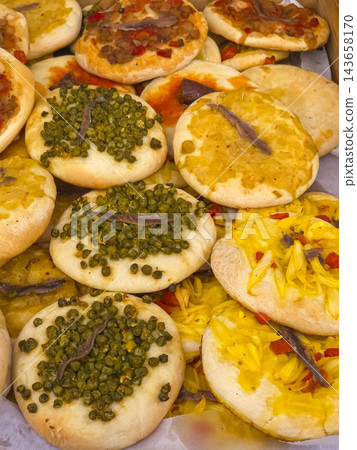 Traditional Spanish Mini Cocas Flatbreads with Assorted Toppings Traditional Spanish Mini Cocas Flatbreads with Assorted Toppings 143658170