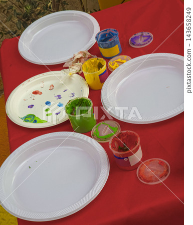 Colorful Kids Finger Paint and Disposable Plates on Table Colorful Kids Finger Paint and Disposable Plates on Table 143658249