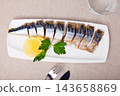 Smoked mackerel fillets with lemon and greens 143658869