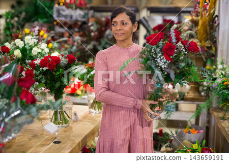 Portrait of a latin american woman choosing a bouquet of flowers Portrait of a latin american woman choosing a bouquet of flowers 143659191