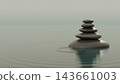 Zen stones piled on the calm, misty surface of the water, creating ripples—a backdrop of healing and balance. 143661003