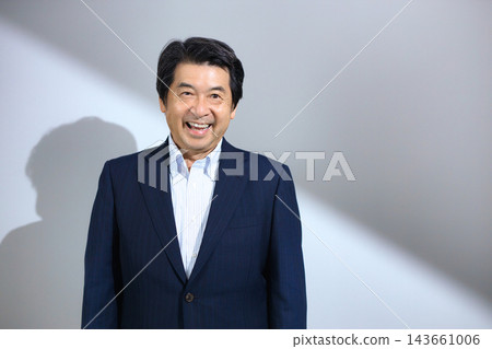 A man in his 60s wearing a suit A man in his 60s wearing a suit 143661006