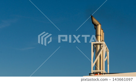 Ferry funnel and structural framework rising against a clear blue sky in warm sunlight, viewed as a close architectural detail Ferry funnel and structural framework rising against a clear blue sky in warm sunlight, viewed as a close architectural detail 143661097
