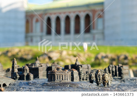 Miniature model depicting Tsaritsyno Park's architecture with a blurred historical building in the background under bright sunlight in Moscow Miniature model depicting Tsaritsyno Park's architecture with a blurred historical building in the background under bright sunlight in Moscow 143661373