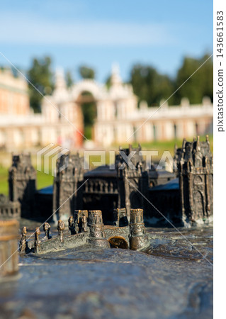 Miniature model representing Tsaritsyno Park with intricate architectural details, showcasing historical buildings and a clear blue sky in the background Miniature model representing Tsaritsyno Park with intricate architectural details, showcasing historical buildings and a clear blue sky in the background 143661583