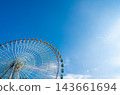 Low angle view of giant colorful ferris wheel against clear blue sky with copy space 143661694
