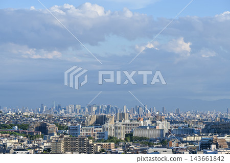 The cityscapes and high-rise apartment buildings of Toyonaka and Minoh cities in northern Osaka, spread out beneath the blue sky and clouds. [Osaka urban landscape photograph] 143661842