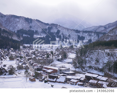 The village of Shirakawa-go and the snow-covered mountains The village of Shirakawa-go and the snow-covered mountains 143662098