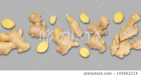 Fresh ginger roots arranged creatively on gray surface 143662214
