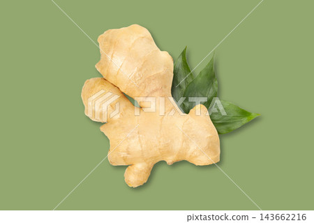 Fresh ginger root sits on green backdrop, showcasing vibrant natural beauty 143662216