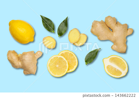 Fresh ginger root and lemon slices are elegantly displayed with green leaves Fresh ginger root and lemon slices are elegantly displayed with green leaves 143662222