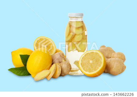 Ginger and lemon slices next to a bottle of ginger-infused water for wellness 143662226