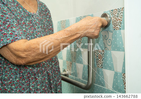 Asian senior woman patient use toilet bathroom handle security in nursing hospital. Asian senior woman patient use toilet bathroom handle security in nursing hospital. 143662788
