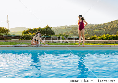 Two Children Playing Poolside at a Luxury Countryside Villa Swimming Pool Two Children Playing Poolside at a Luxury Countryside Villa Swimming Pool 143662866