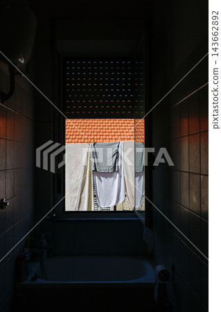 Towels Drying on Clothesline Outside Window, Mediterranean Home with Terracotta Roof Towels Drying on Clothesline Outside Window, Mediterranean Home with Terracotta Roof 143662892