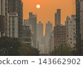 Hong Kong Oct 13 2026 Glowing Crimson Sun Setting Between High Rise Skyscrapers 143662902