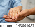 Caregiver holding hands Asian elderly woman patient, help and care in hospital. 143664683
