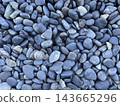 A natural stone texture background covered with blue-gray pebbles. 143665296