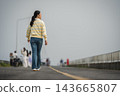 woman walking on a road on mountain in morning 143665807