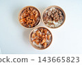 Top view of three Asian rice bowls in takeaway containers featuring beef, spicy pork, and fried chicken over white rice. Arranged on a clean white background for food delivery concepts. 143665823