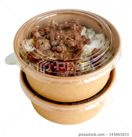 Two stacked kraft paper bowls with clear plastic lids containing grilled meat over white rice. Sustainable food packaging for takeaway or delivery isolated. Two stacked kraft paper bowls with clear plastic lids containing grilled meat over white rice. Sustainable food packaging for takeaway or delivery isolated. 143665833