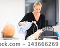 Medical doctor specialist expert displaying method of patient intubation technique on hands on medical education training and workshop. 143666269
