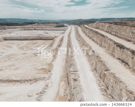 Aerial View of Large Open Pit Quarry with Terraced Rock Excavation and Haul Roads Aerial View of Large Open Pit Quarry with Terraced Rock Excavation and Haul Roads 143666324