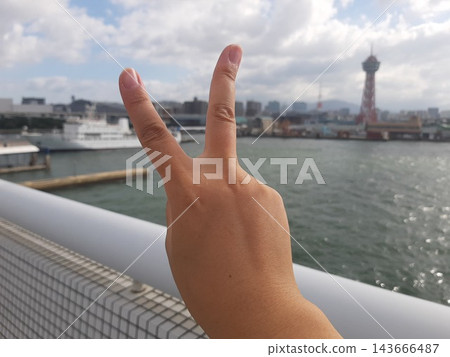 A hand making a peace sign and the scenery A hand making a peace sign and the scenery 143666487