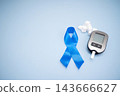 Diabetes concept with blood glucose meter, sugar cubes, blue awareness ribbon and medical gloves on blue background 143666627