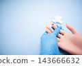 Diabetes concept with blood glucose meter, sugar cubes, blue awareness ribbon and medical gloves on blue background 143666632