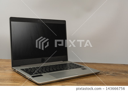 Laptop on a wooden desk in a modern workspace ready for work Laptop on a wooden desk in a modern workspace ready for work 143666756